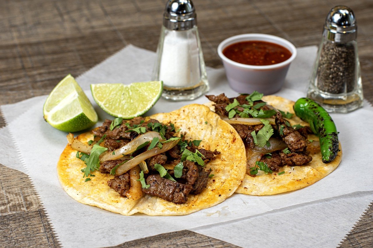 Carne asada tacos served on plate